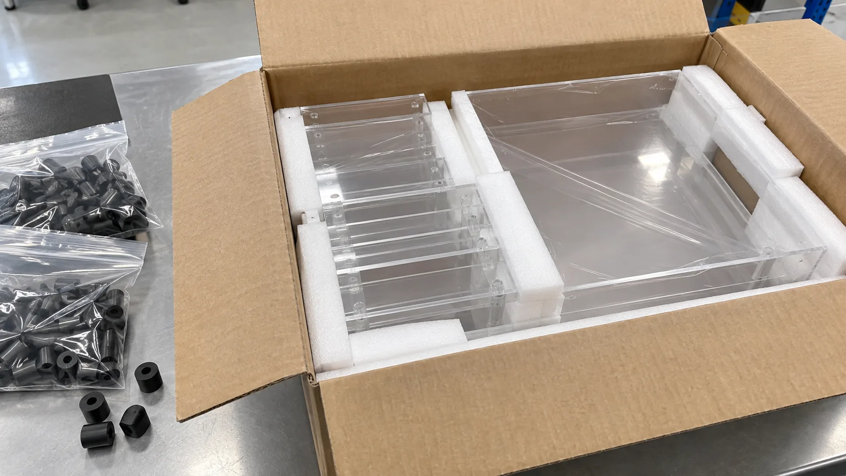 Custom acrylic parts packed beside nylon hardware spacers